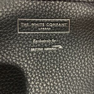 The white company London black cosmetics bag . New